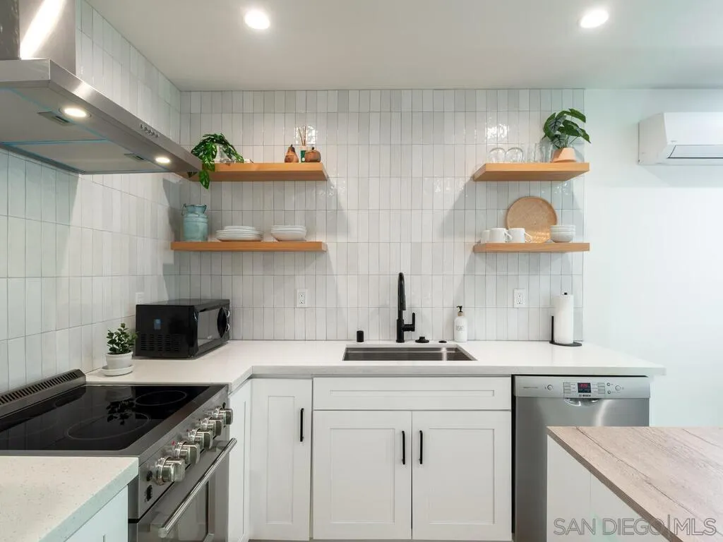 4751 Altadena Avenue San Diego, CA 92115 - Photo 41 of 47 a kitchen with a sink cabinets and stove top oven