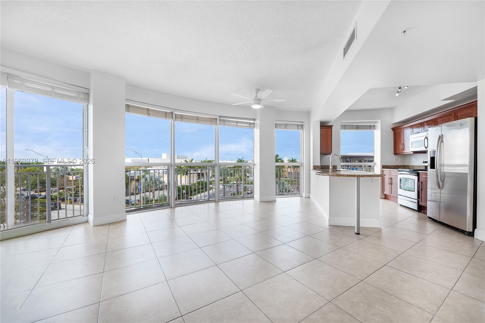 a view of kitchen with granite countertop stainless steel appliances and counter space
