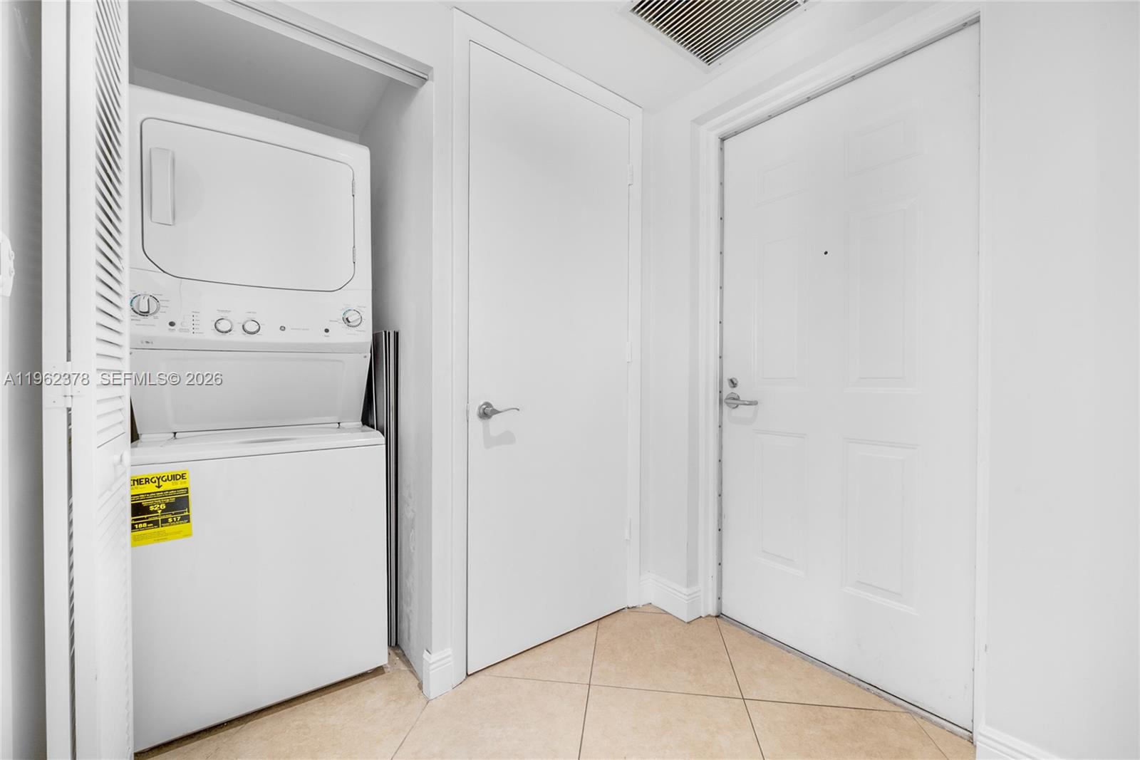 7270 Southwest 88th Street, Unit B303 Miami, FL 33156 - Photo 14 of 15 a view of storage and utility room with washer and dryer