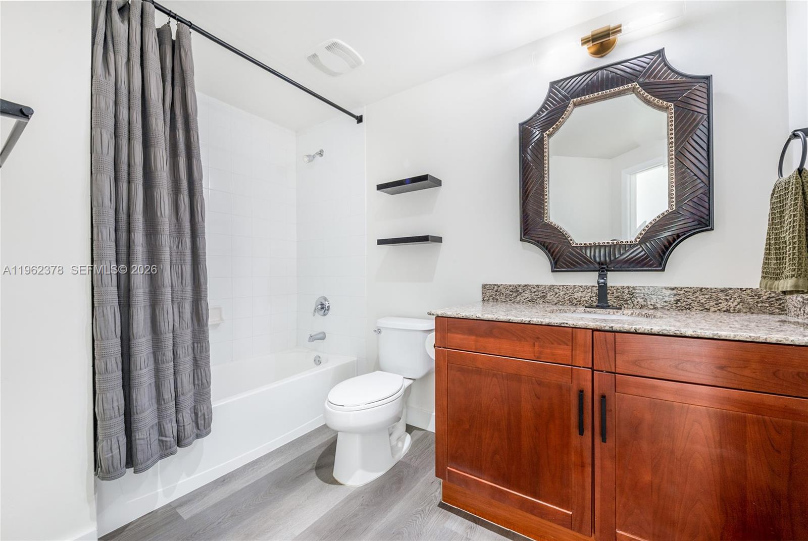 7270 Southwest 88th Street, Unit B303 Miami, FL 33156 - Photo 8 of 15 a bathroom with a toilet sink and mirror