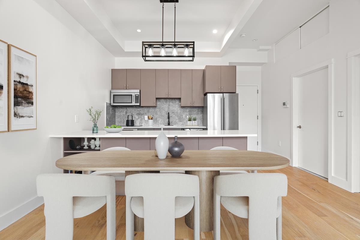 5-12 51st Avenue, Unit 2A Queens, NY 11101 - Photo 1 of 8 a kitchen with kitchen island granite countertop a sink and refrigerator