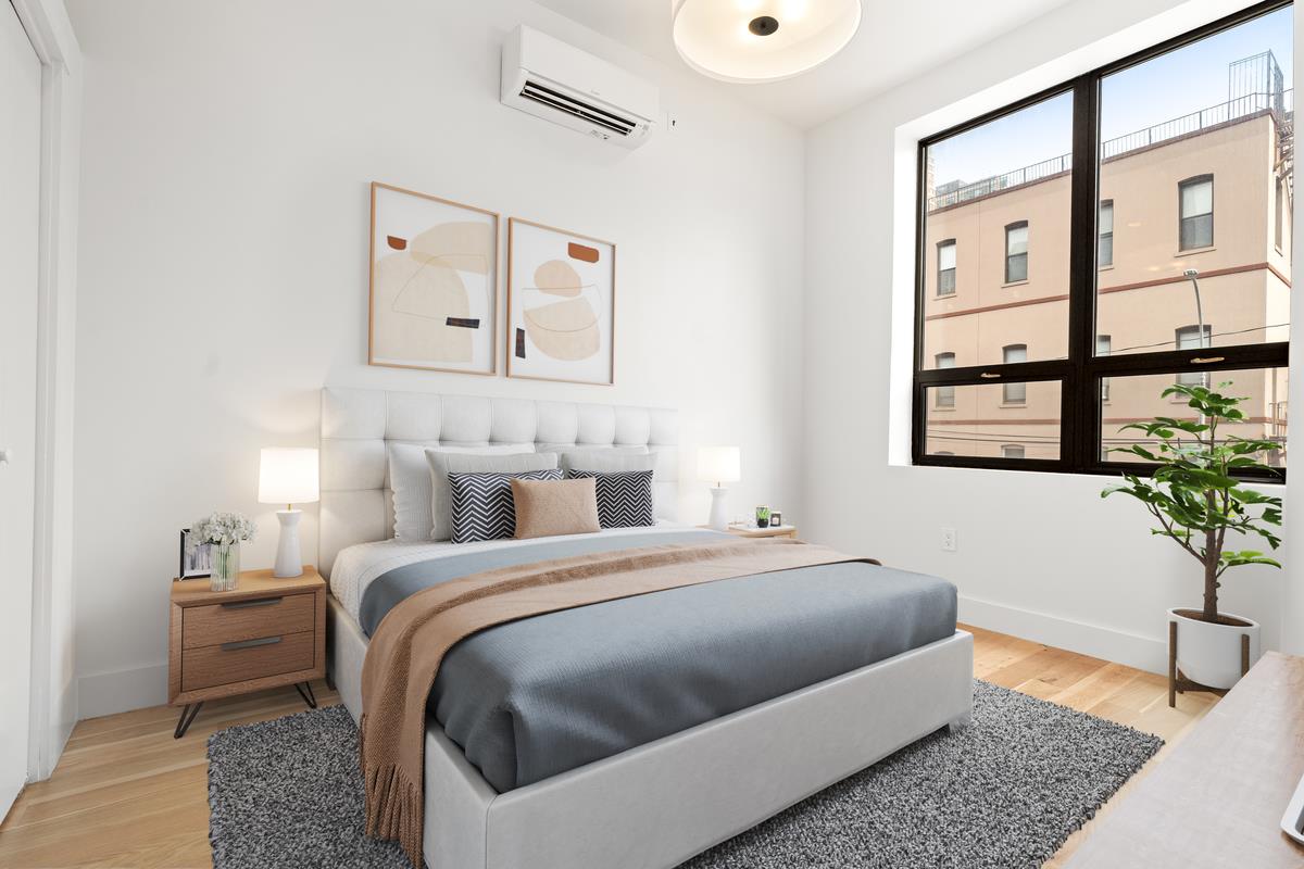 5-12 51st Avenue, Unit 2A Queens, NY 11101 - Photo 5 of 8 a bedroom with a bed and a potted plant