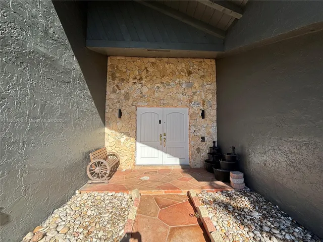 a bedroom with a bed and a wooden floor