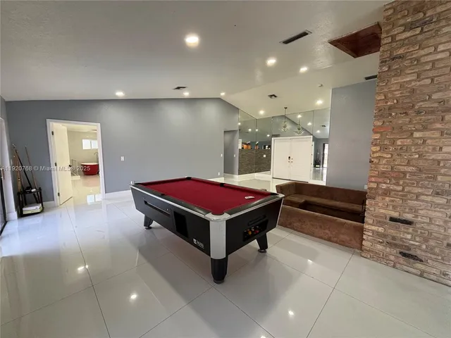 a room with pool table and a flat screen tv
