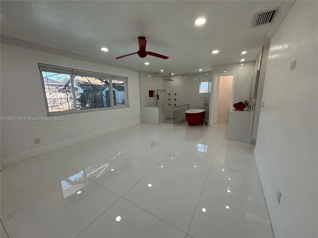 a view of a lobby room with furniture and a ceiling fan