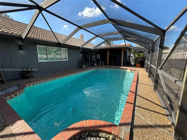 a view of swimming pool with a yard