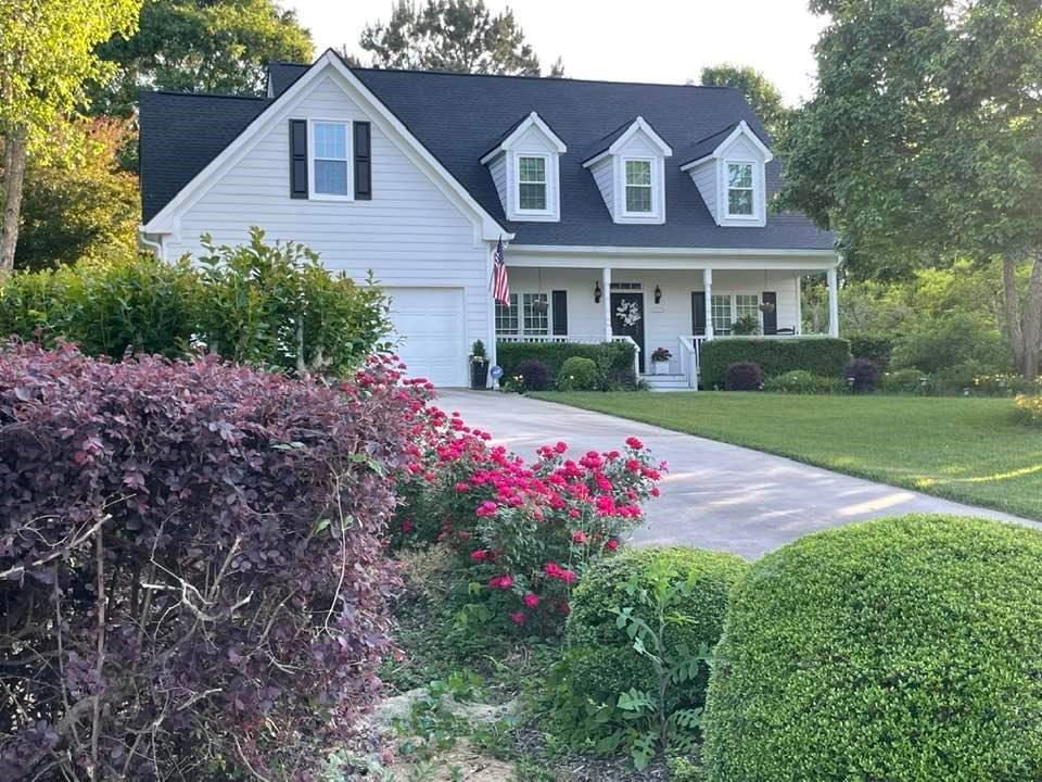 4855 Sewell Road Cumming, GA 30028 - Photo 1 of 1 a front view of a house with a yard and garage