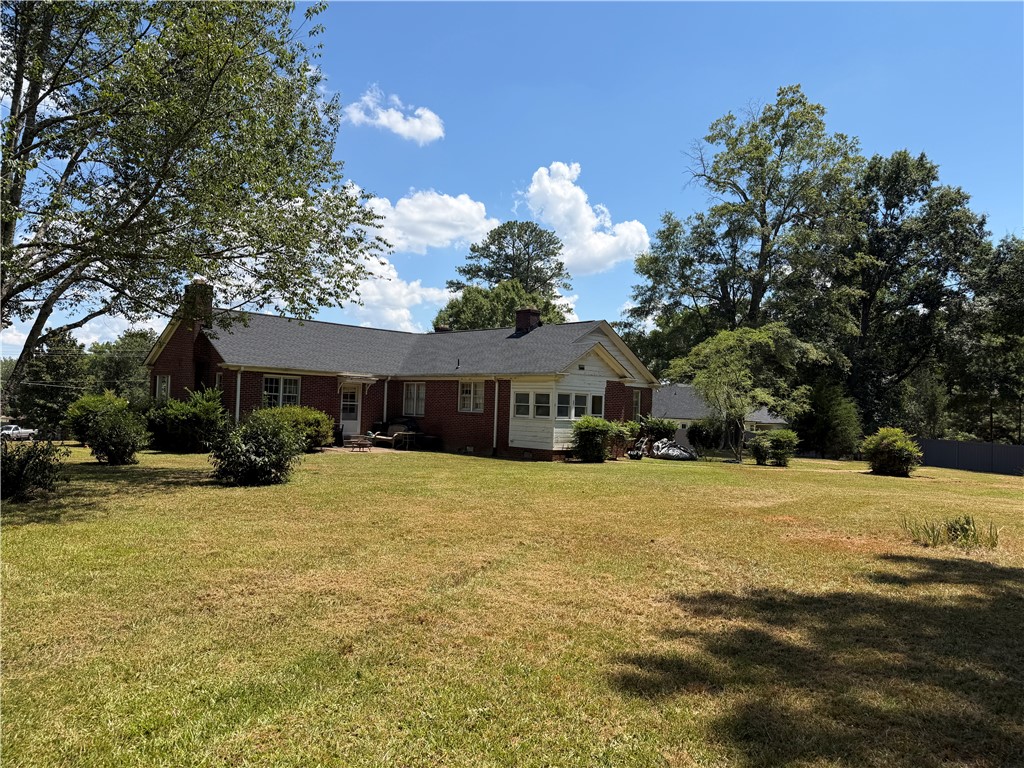 715 Concord Road Anderson, SC 29621 - Photo 6 of 24 Mature trees and ample green space define this charming home with a broad back lawn.