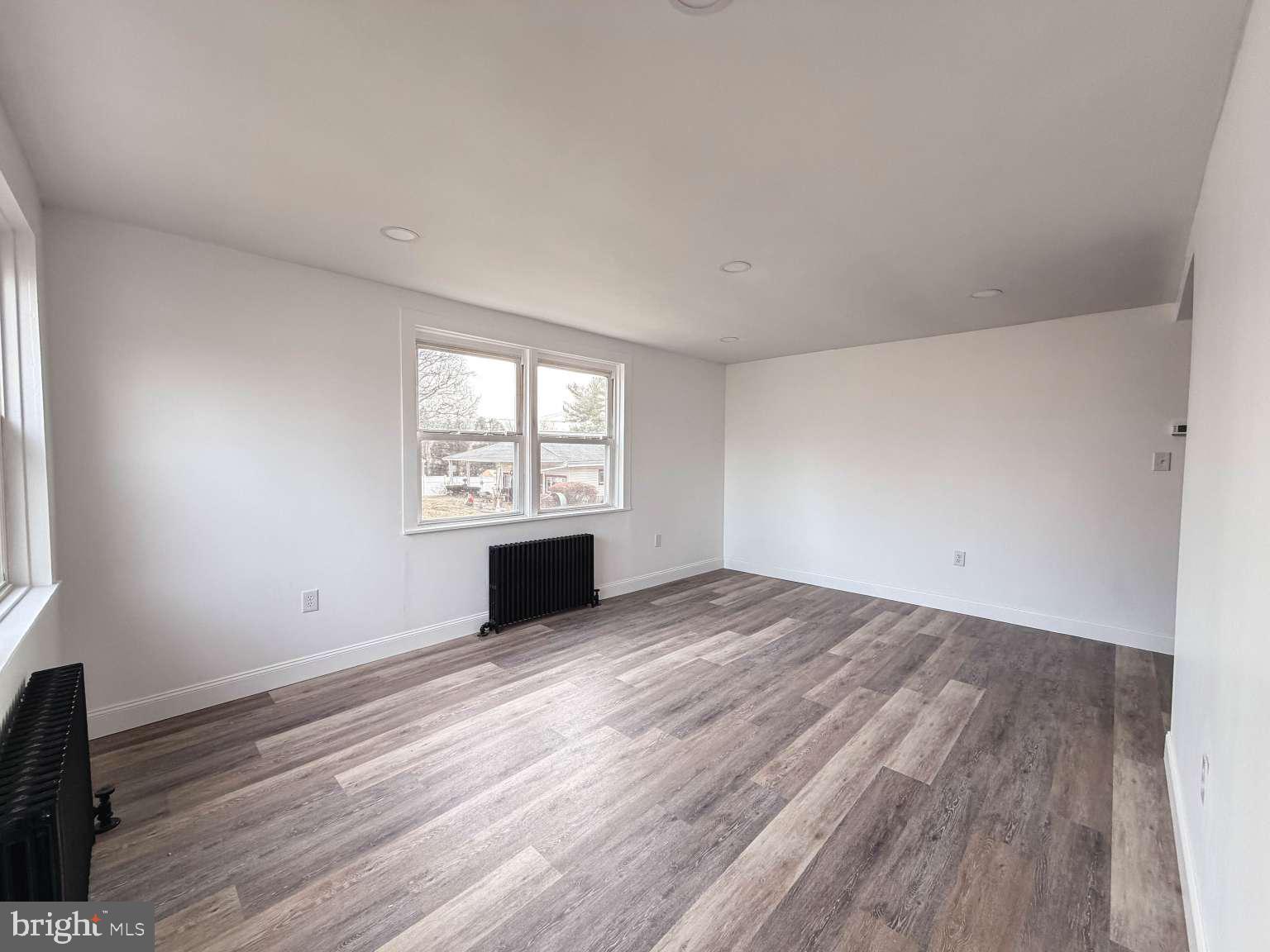 1424 Wayne Street Reading, PA 19601 - Photo 3 of 19 wooden floor in an empty room with a window