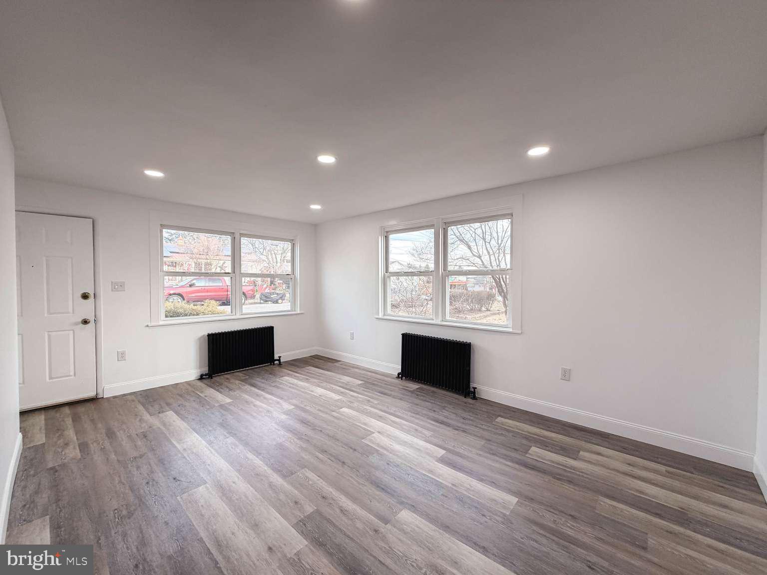 1424 Wayne Street Reading, PA 19601 - Photo 4 of 19 a view of an empty room with wooden floor and a window