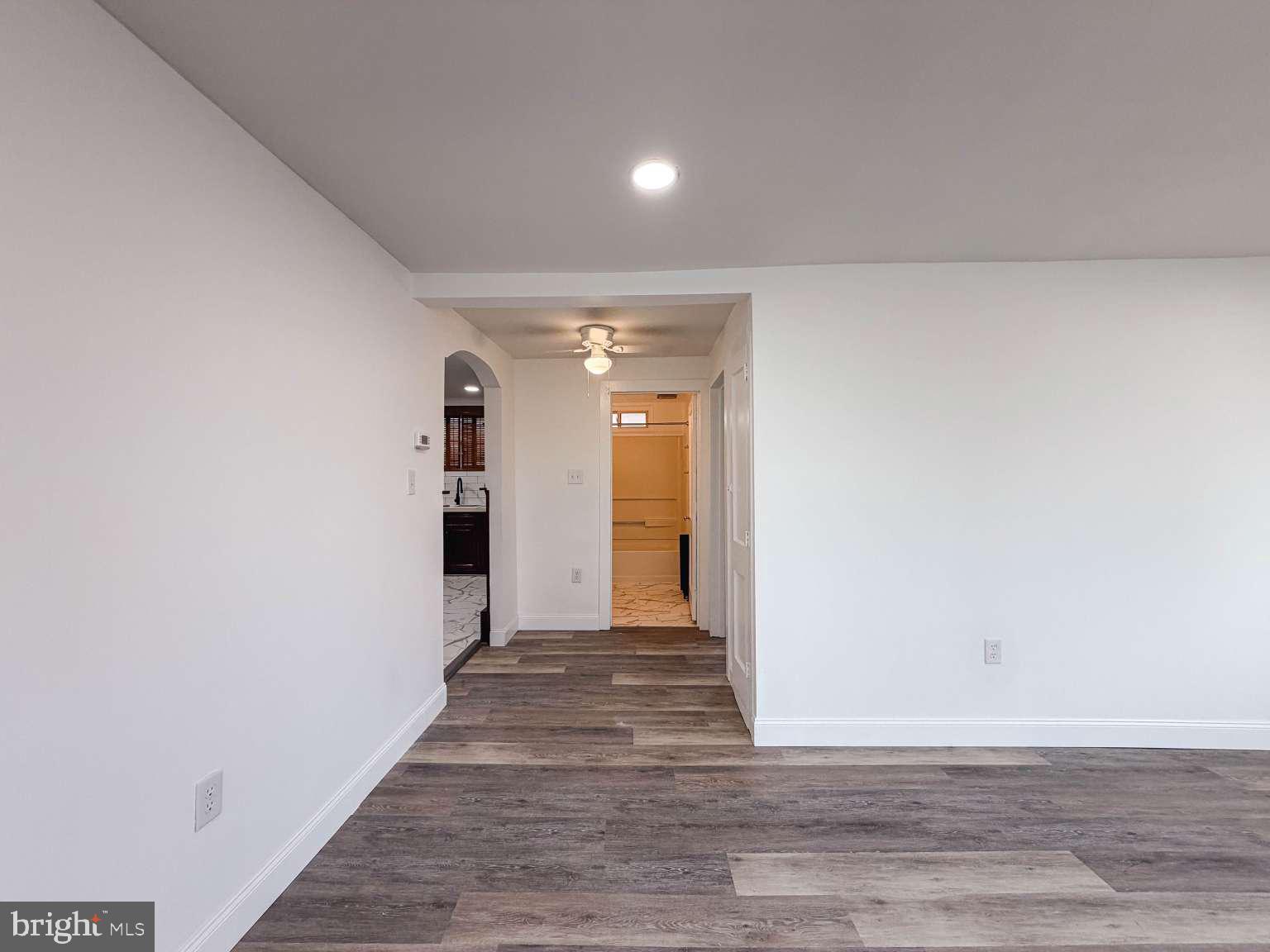 1424 Wayne Street Reading, PA 19601 - Photo 5 of 19 a view of a hallway with wooden floor and a bathroom