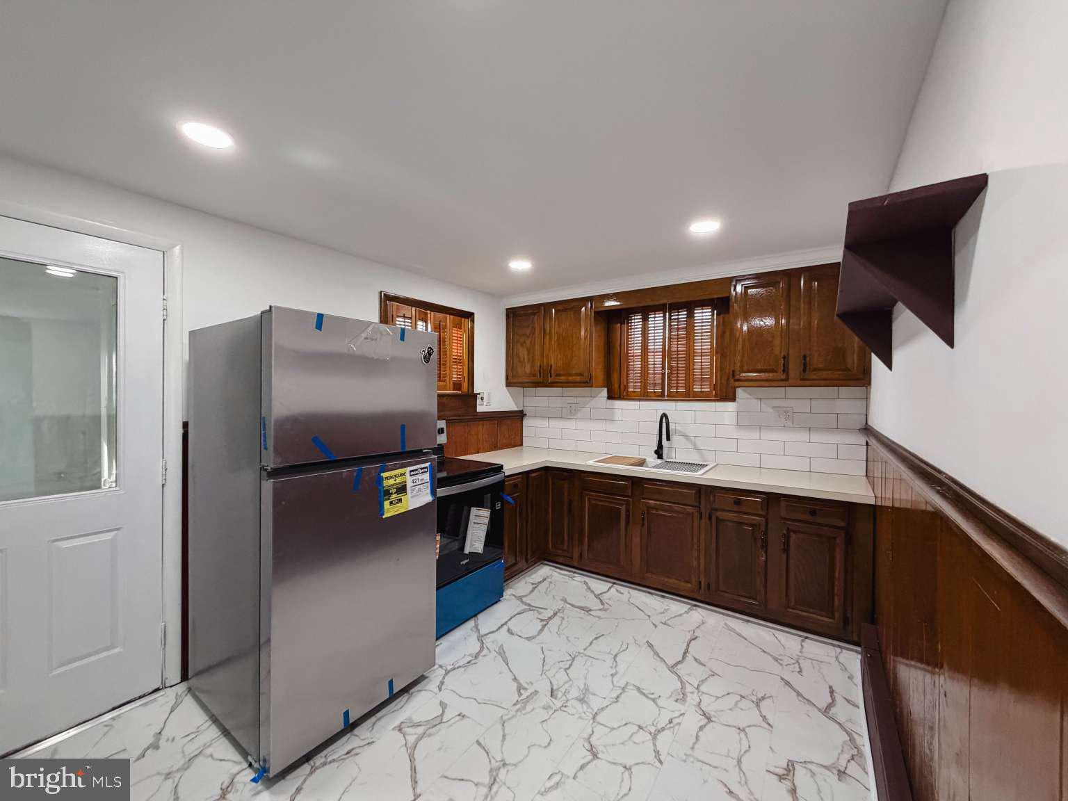 1424 Wayne Street Reading, PA 19601 - Photo 7 of 19 a kitchen with stainless steel appliances granite countertop a refrigerator and a sink