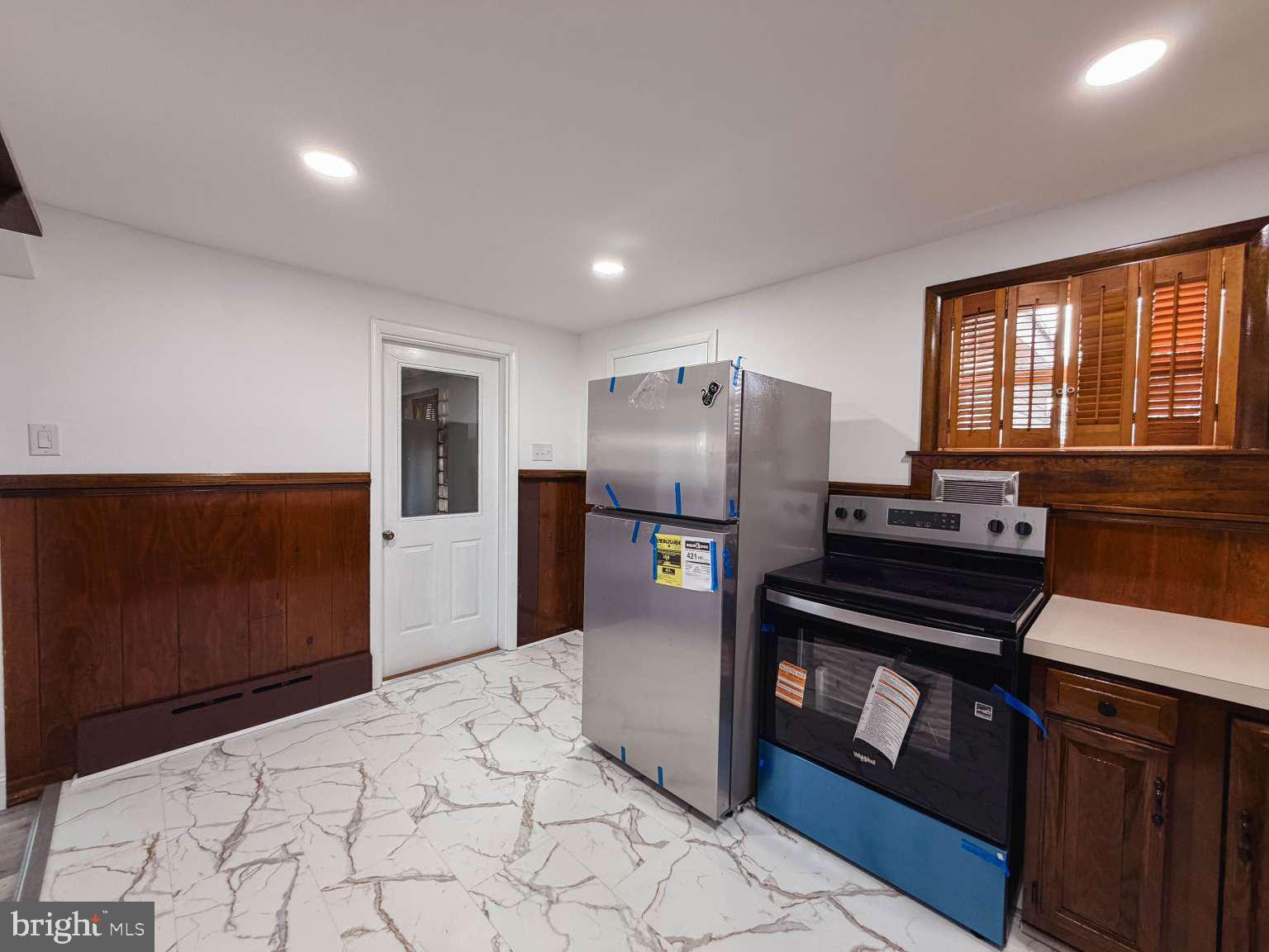 1424 Wayne Street Reading, PA 19601 - Photo 8 of 19 a kitchen with stainless steel appliances a refrigerator and a stove top oven