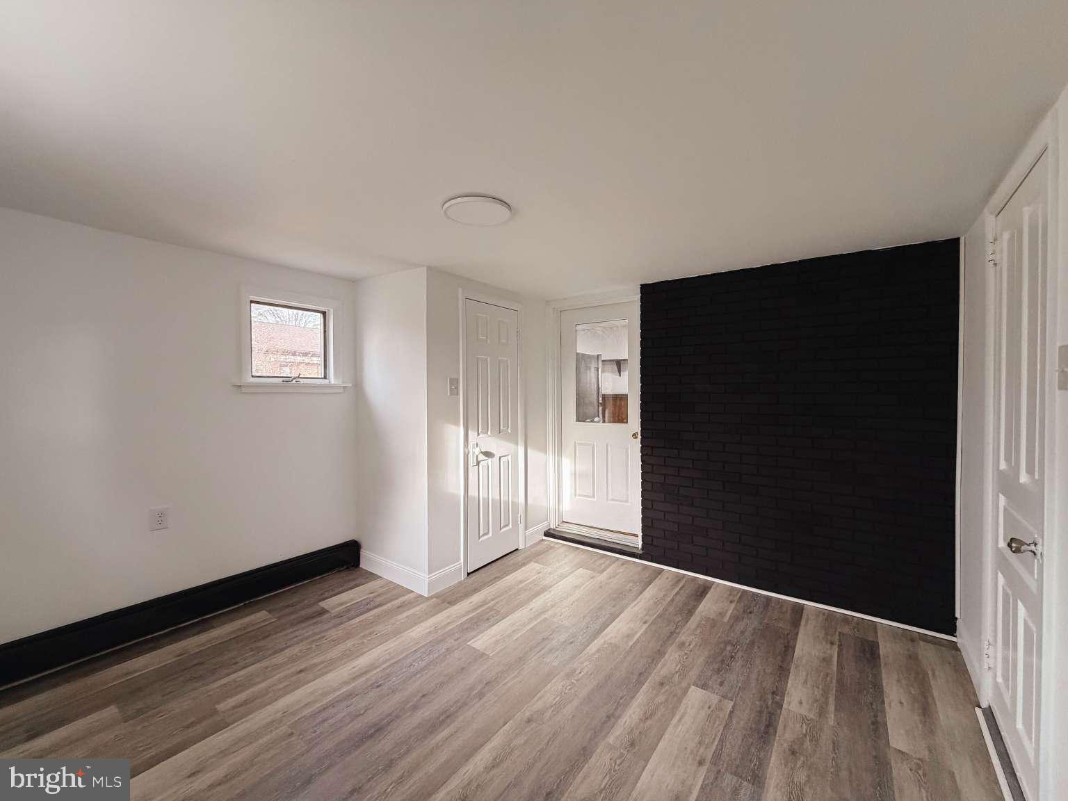 1424 Wayne Street Reading, PA 19601 - Photo 10 of 19 a view of an empty room with wooden floor and a window