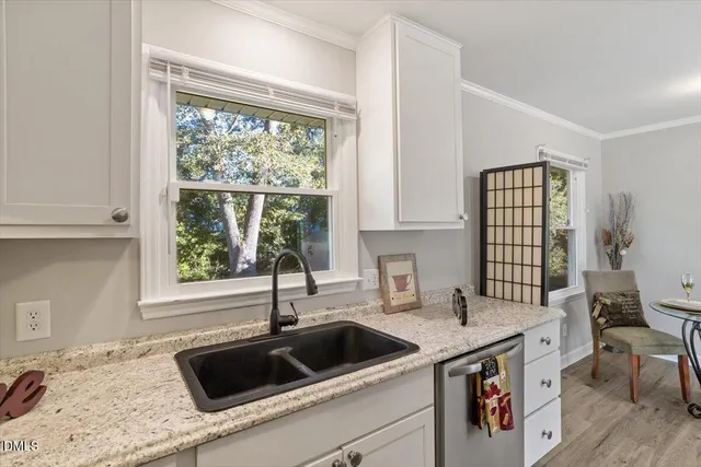 a kitchen with a sink cabinets and window