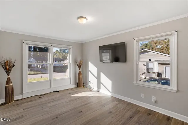 wooden floor in an empty room with a window