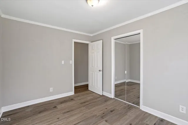 a view of an empty room with wooden floor