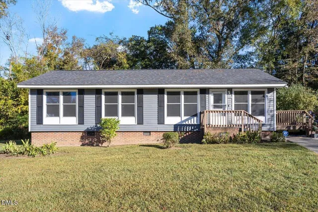 a front view of a house with a garden and porch