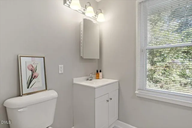 a bathroom with a toilet a sink and a window