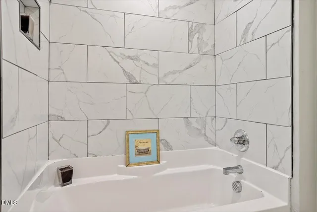 a white bath tub and a window