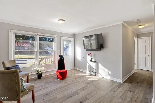 a living room with furniture wooden floor and a flat screen tv