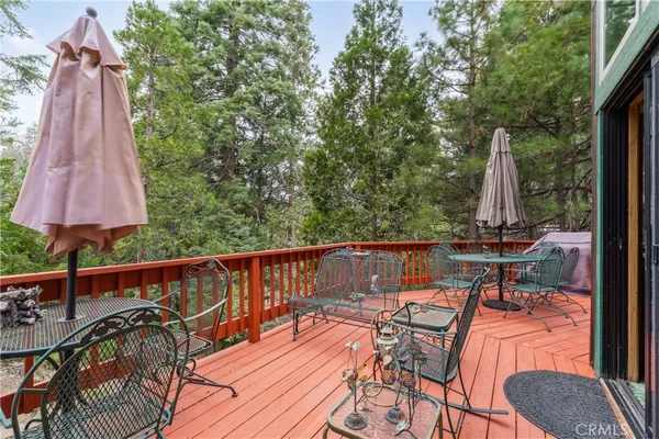 a view of a patio with a table chairs and a wooden deck