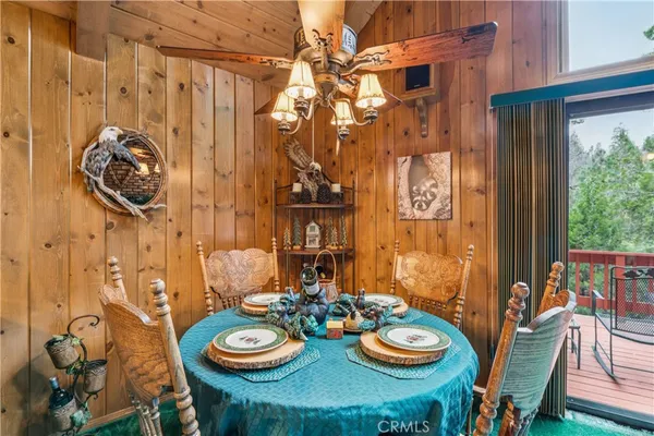 a view of a dining room with furniture and chandelier
