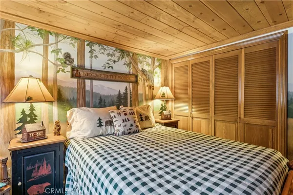 a bedroom with a bed and a night stand