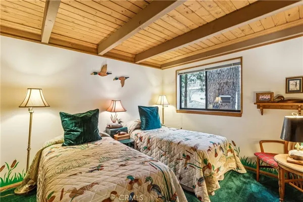 a bedroom with a bed and lamp
