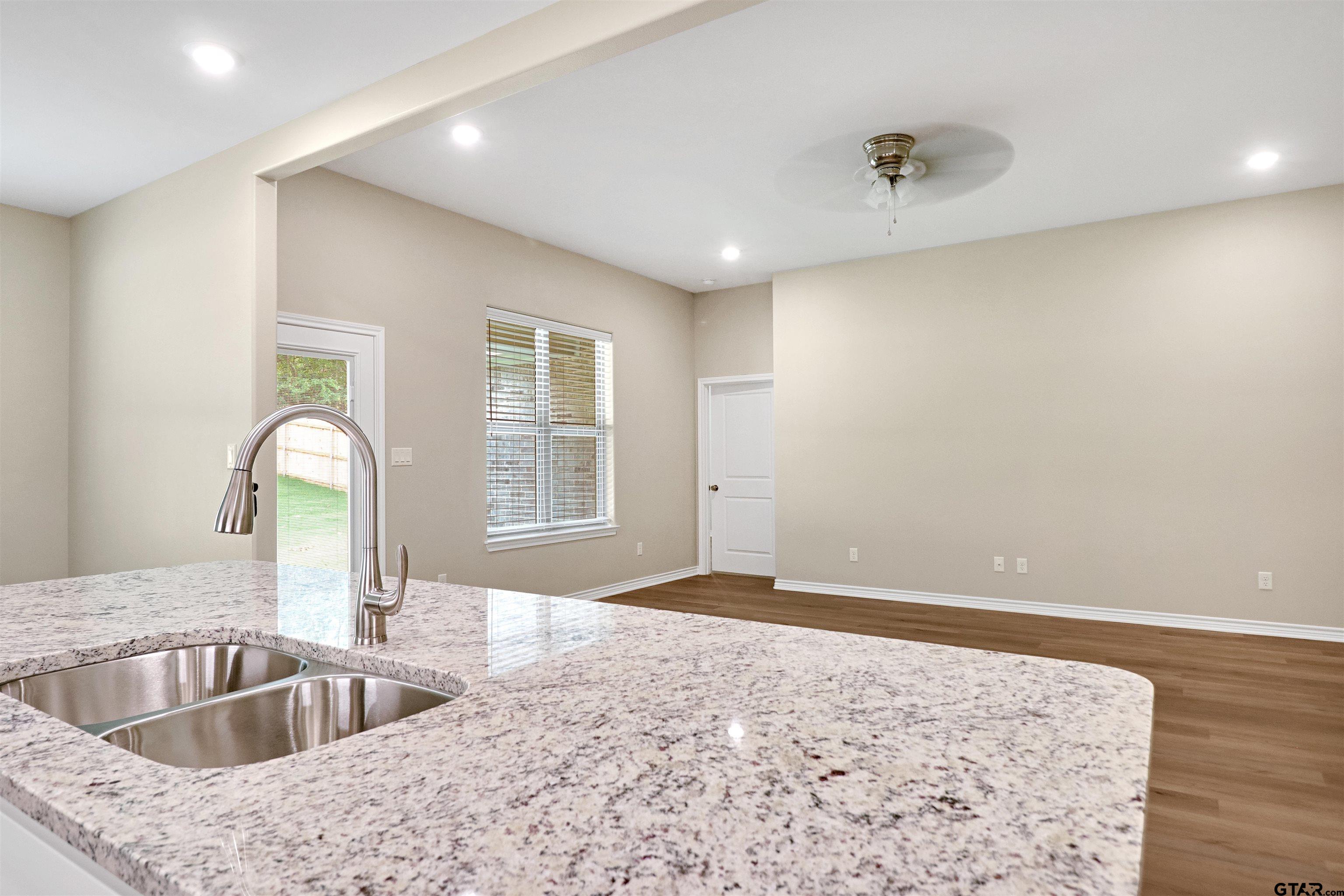 3053 Guinn Farms Road Tyler, TX 75707 - Photo 11 of 32 a kitchen with a sink and a refrigerator