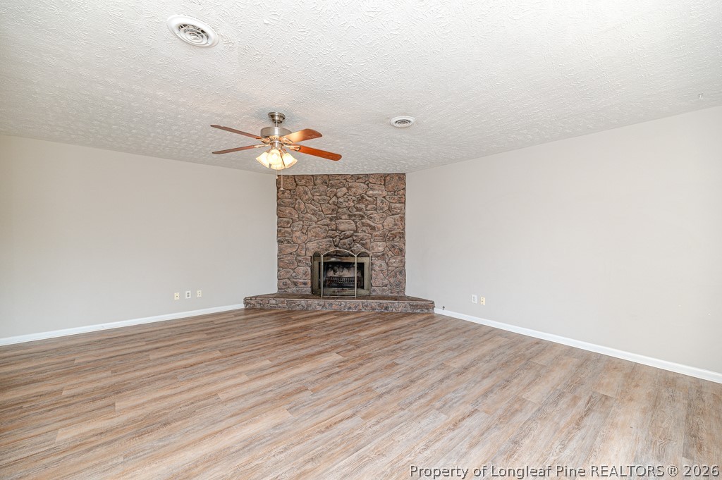 6553 Grist Mill Road Fayetteville, NC 28314 - Photo 16 of 31 a view of an empty room with wooden floor