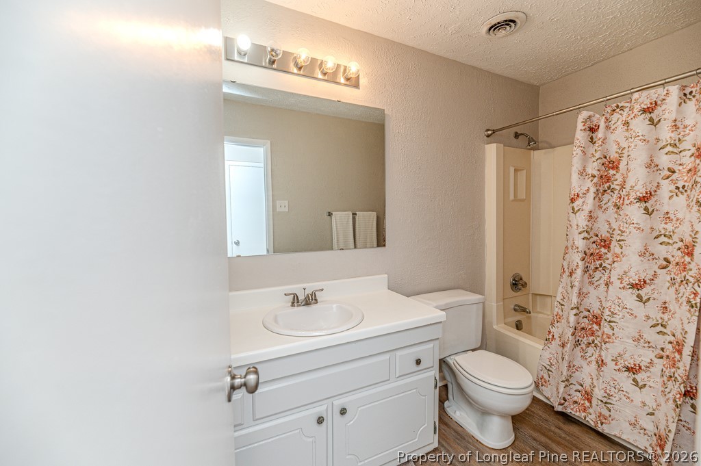 6553 Grist Mill Road Fayetteville, NC 28314 - Photo 20 of 31 a bathroom with a sink toilet a mirror and shower