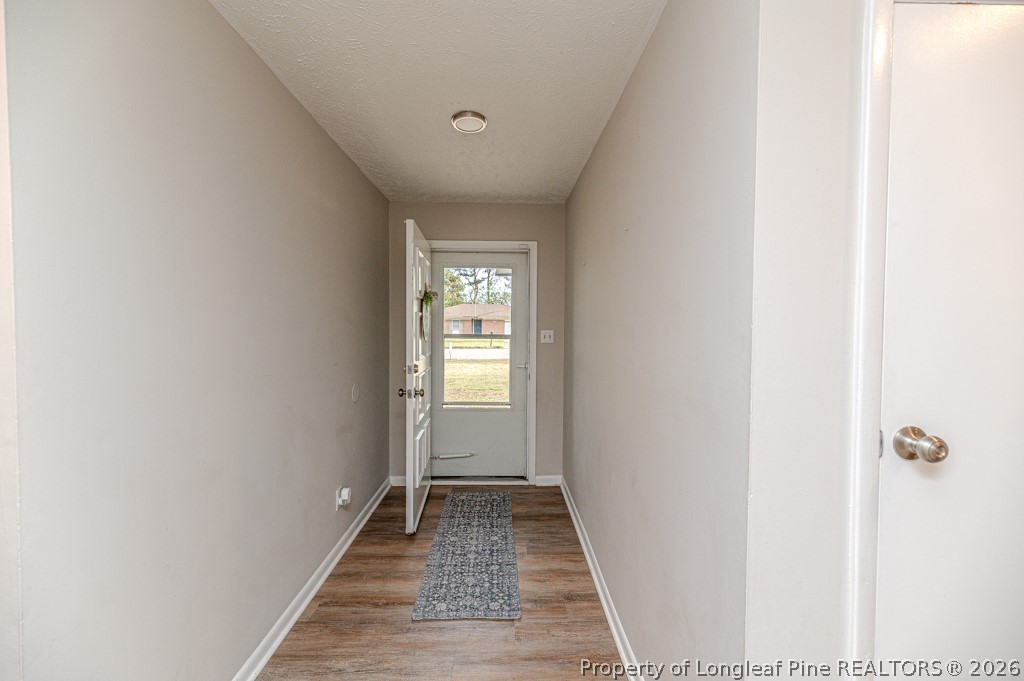 6553 Grist Mill Road Fayetteville, NC 28314 - Photo 3 of 31 a view of a hallway with wooden floor