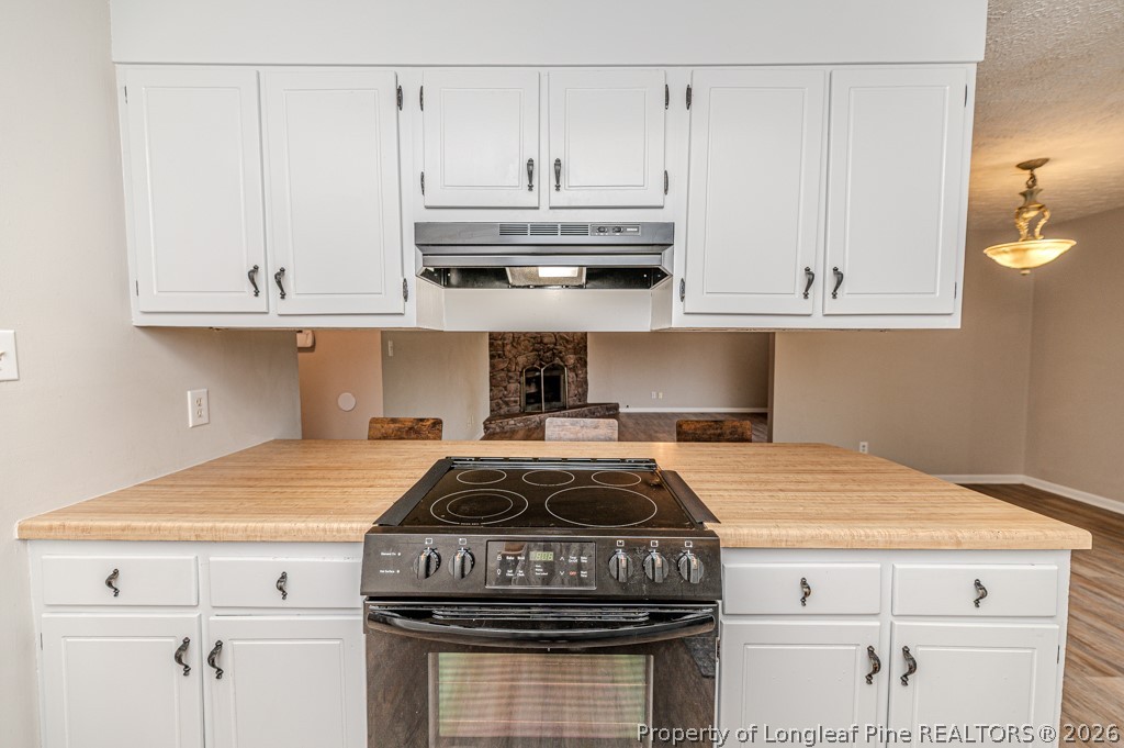 6553 Grist Mill Road Fayetteville, NC 28314 - Photo 7 of 31 a kitchen with granite countertop a stove and a white cabinets