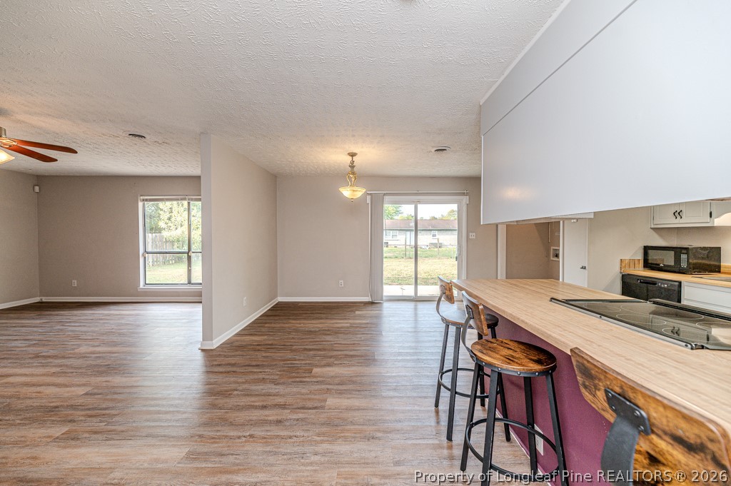 6553 Grist Mill Road Fayetteville, NC 28314 - Photo 10 of 31 a view of a kitchen and dining room with furniture window and wooden floor