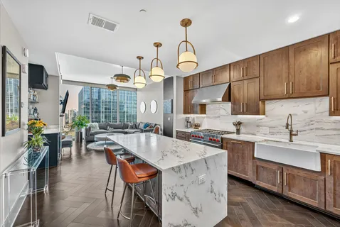 a kitchen with stainless steel appliances granite countertop a sink a stove and a refrigerator