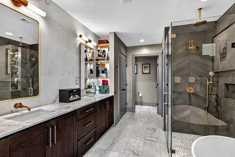 a spacious bathroom with a shower sink and mirror