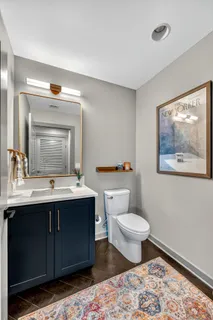 a bathroom with a toilet sink and mirror