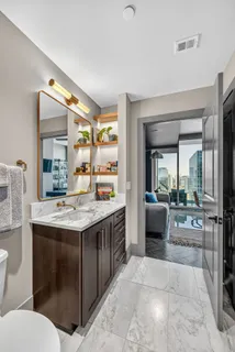 a spacious bathroom with a granite countertop sink mirror and bathtub