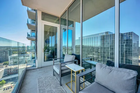 a balcony with furniture and a garden
