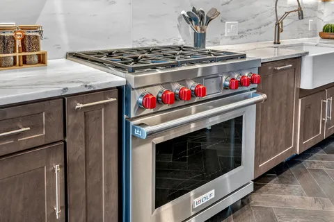 a kitchen with granite countertop a stove and a sink