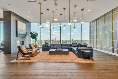 a living room with fireplace furniture and a floor to ceiling window