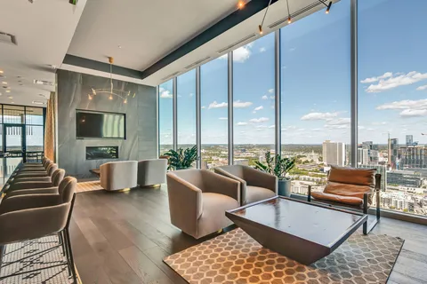 a living room with furniture pool table and a large window
