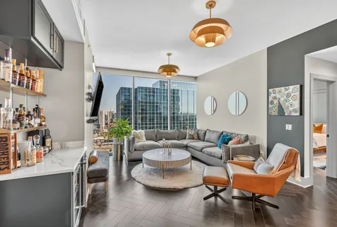 a living room with furniture and a large window