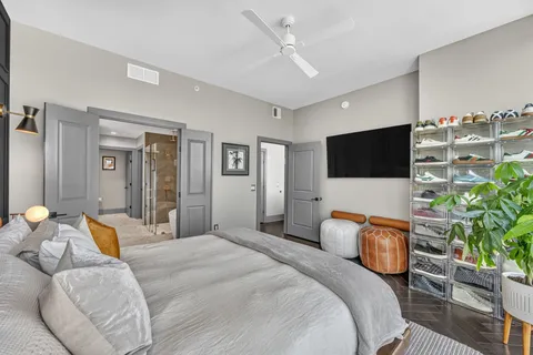 a bedroom with a bed and a flat screen tv