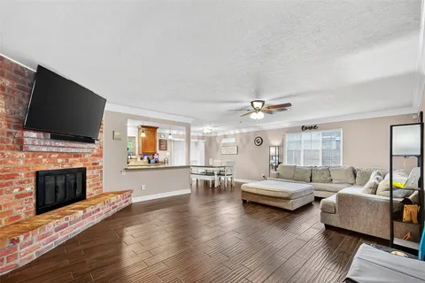 a living room with fireplace furniture and a flat screen tv