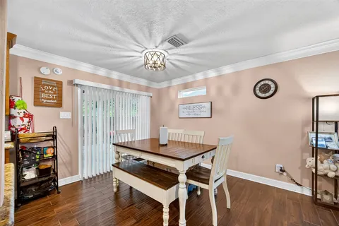 a view of a workspace with furniture and wooden floor