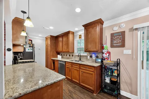 a kitchen with stainless steel appliances granite countertop sink stove and refrigerator