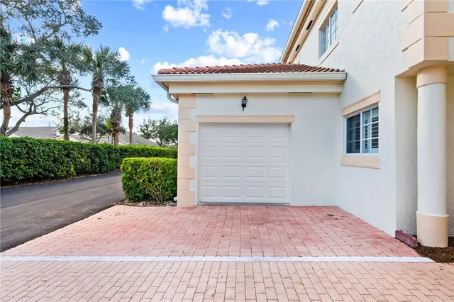 a front view of a house with plants