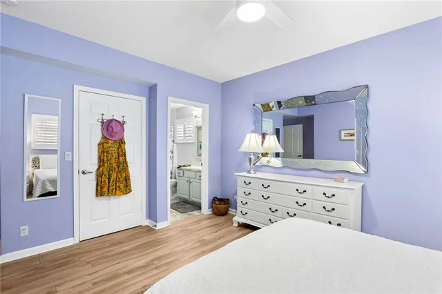 a view of kitchen cabinets with stainless steel appliances granite countertop a sink and a refrigerator